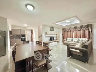 Spacious open-plan living and dining area with modern furnishings and ample natural light.