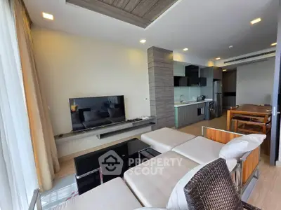 Modern living room with open kitchen and stylish decor in a contemporary apartment.