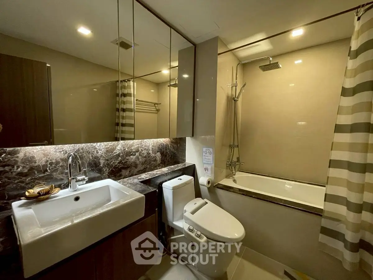 Luxurious modern bathroom with elegant marble accents and sleek fixtures.