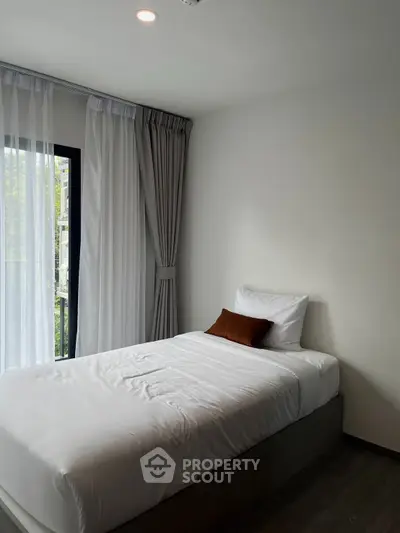 Cozy minimalist bedroom with natural light and modern decor