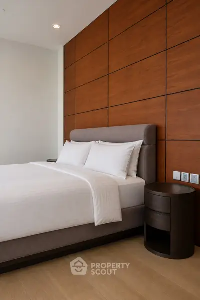 Modern bedroom with stylish wooden paneling and elegant bed setup