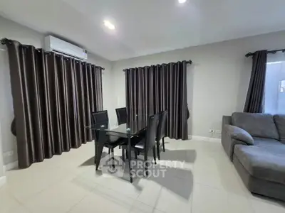 Modern living room with glass dining table and elegant curtains