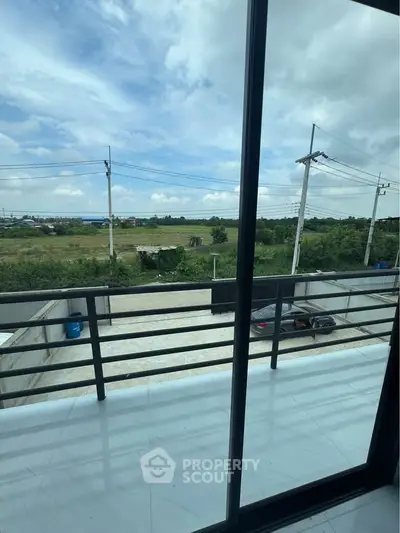 Spacious balcony with scenic countryside view, perfect for relaxation and enjoying nature's beauty.