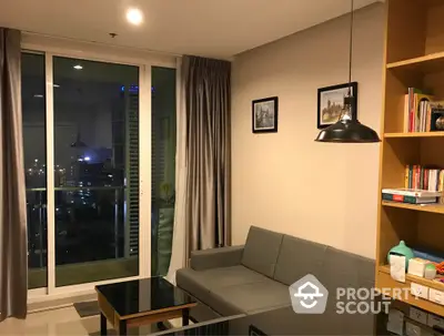 Modern living room with city view, cozy sofa, and stylish decor.