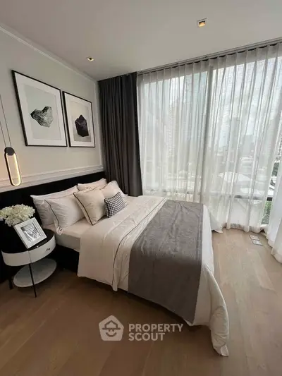 Luxurious bedroom with city view, featuring elegant decor and floor-to-ceiling windows.