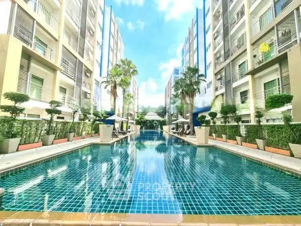 Luxurious apartment complex with stunning outdoor pool and modern architecture.