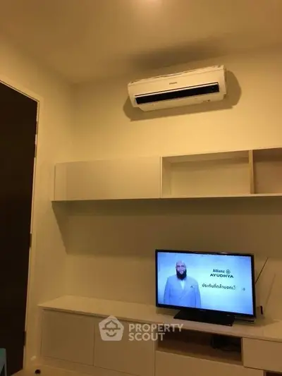 Modern living room with air conditioner and TV setup