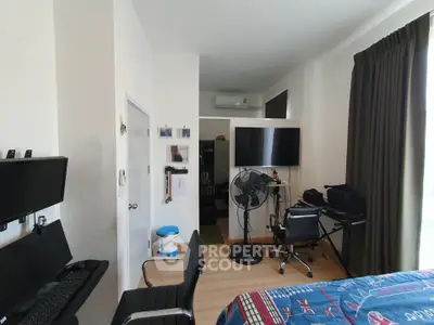 Modern bedroom with workspace and TV, ideal for urban living.