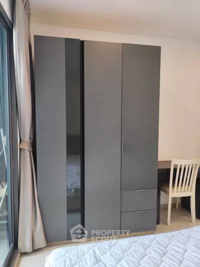 Modern bedroom with sleek wardrobe and cozy ambiance