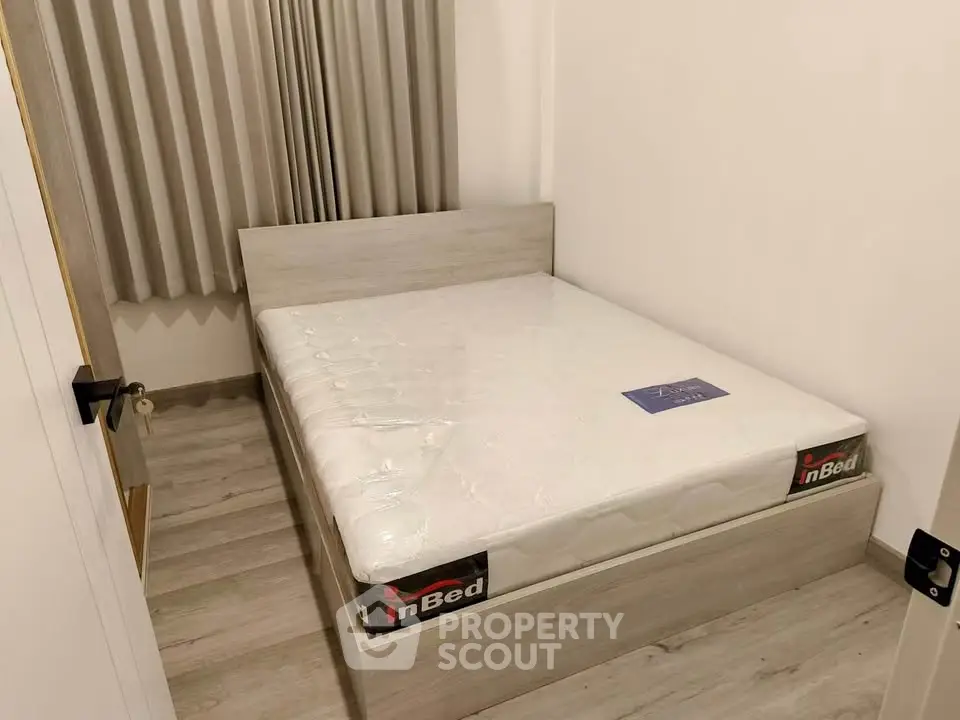 Cozy bedroom with modern bed and neutral decor, perfect for restful nights.