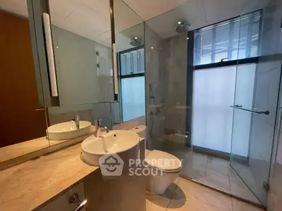 Modern bathroom with glass shower and marble countertop