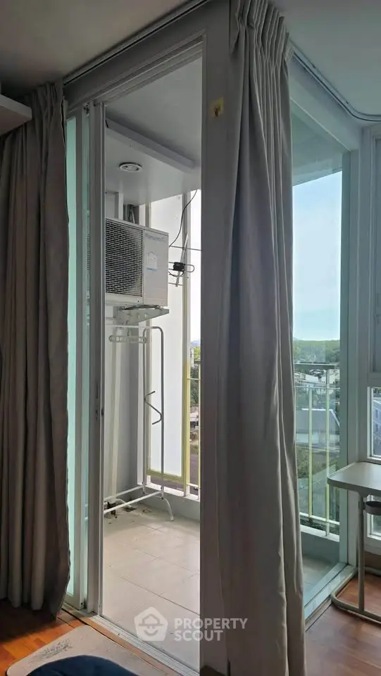Modern apartment balcony with air conditioning unit and city view