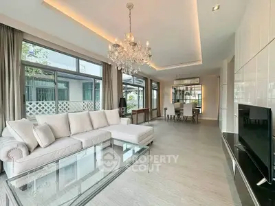 Spacious modern living room with elegant chandelier and large windows