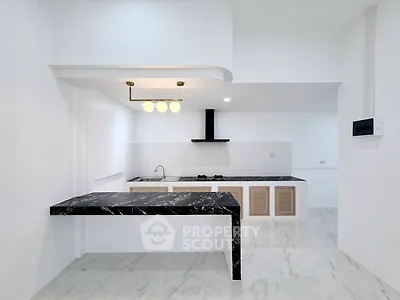 Modern kitchen with sleek black marble countertops and open layout design