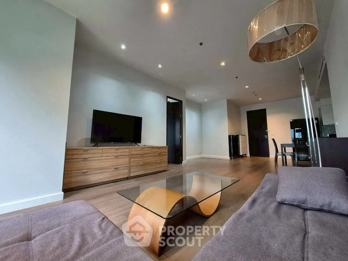 Spacious modern living room with stylish furniture and wooden flooring