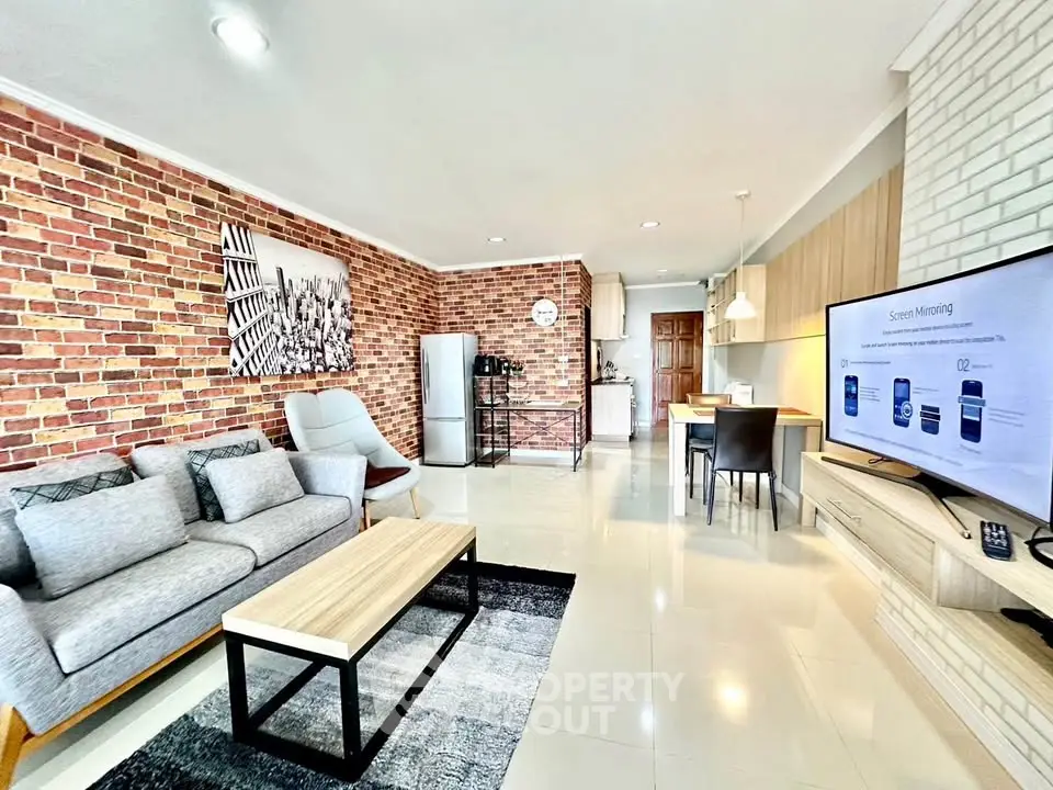 Modern open-plan living room with stylish brick walls and sleek furniture
