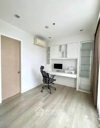 Modern study room with built-in desk and ergonomic chair, featuring sleek design and ample natural light.