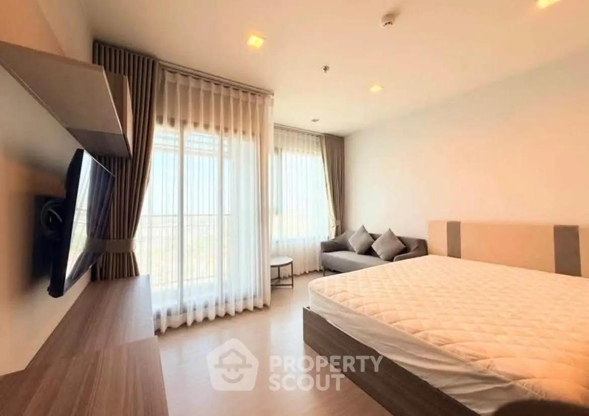 Modern bedroom with large window and stylish decor