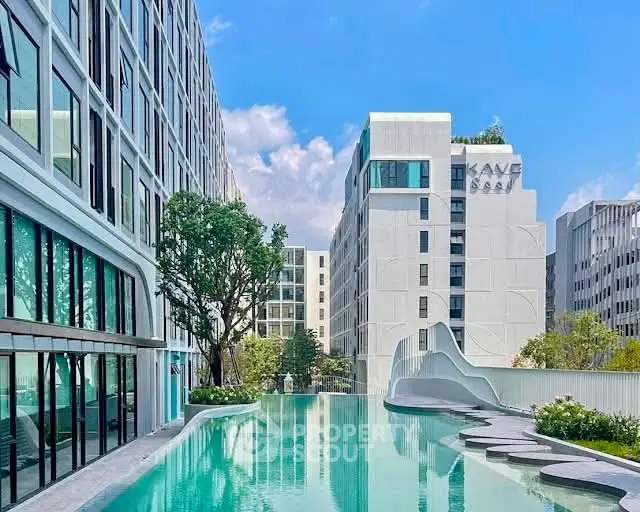 Luxurious modern apartment complex with stunning rooftop pool and city views.