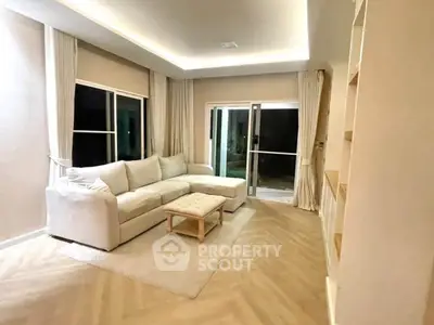 Spacious living room with elegant lighting and cozy seating in modern home