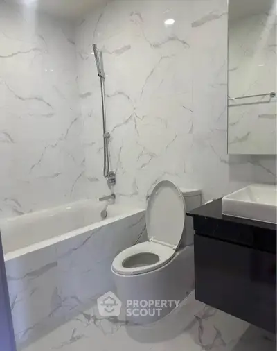 Modern bathroom with marble tiles and sleek fixtures