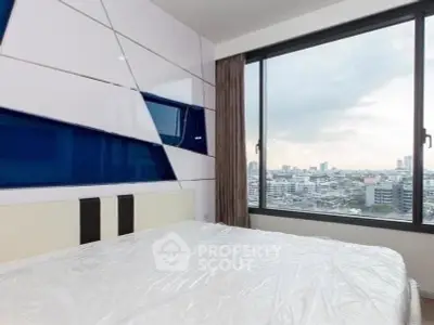 Modern bedroom with large window offering stunning cityscape view