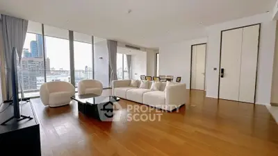 Luxurious modern living room with panoramic city views and elegant furnishings.
