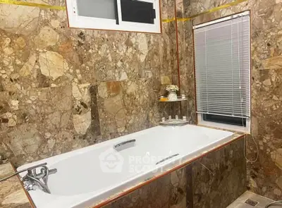 Luxurious marble bathroom with elegant bathtub and modern window blinds