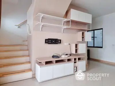 Modern interior with sleek storage and staircase, perfect for stylish living.