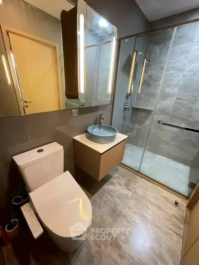 Modern bathroom with sleek fixtures and spacious shower area.