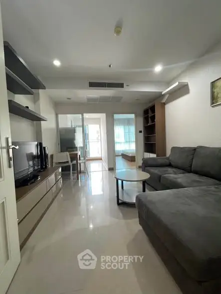Spacious modern living room with sleek furniture and open layout, perfect for relaxation and entertainment.