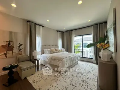 Elegant bedroom with large windows and stylish decor