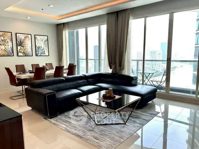 Luxurious living room with modern decor and stunning city view from large windows.