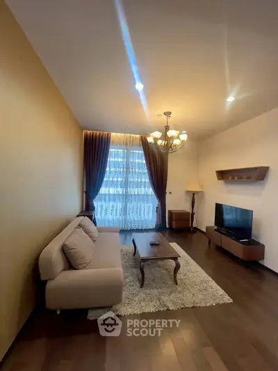 Elegant living room with modern decor, cozy sofa, and stylish lighting, perfect for relaxation and entertainment.