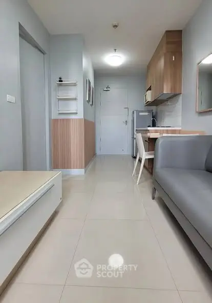 Modern apartment interior with sleek kitchen and cozy living area, perfect for urban living.
