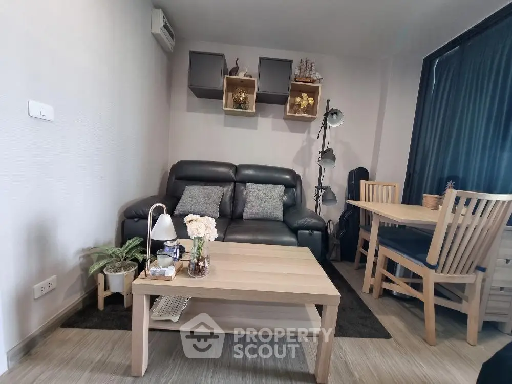 Cozy living room with modern decor, featuring a leather sofa, wooden coffee table, and dining area.