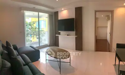 Spacious living room with modern decor and balcony access in a stylish apartment.
