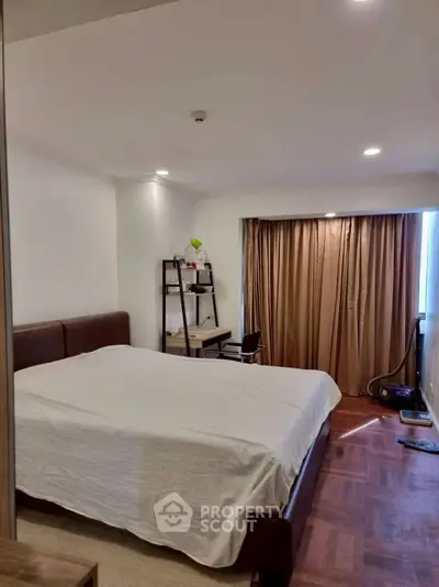 Cozy bedroom with modern furnishings and natural light