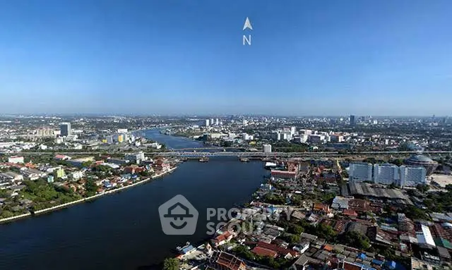 Stunning aerial view of a vibrant cityscape with river and expansive skyline, ideal for urban living.