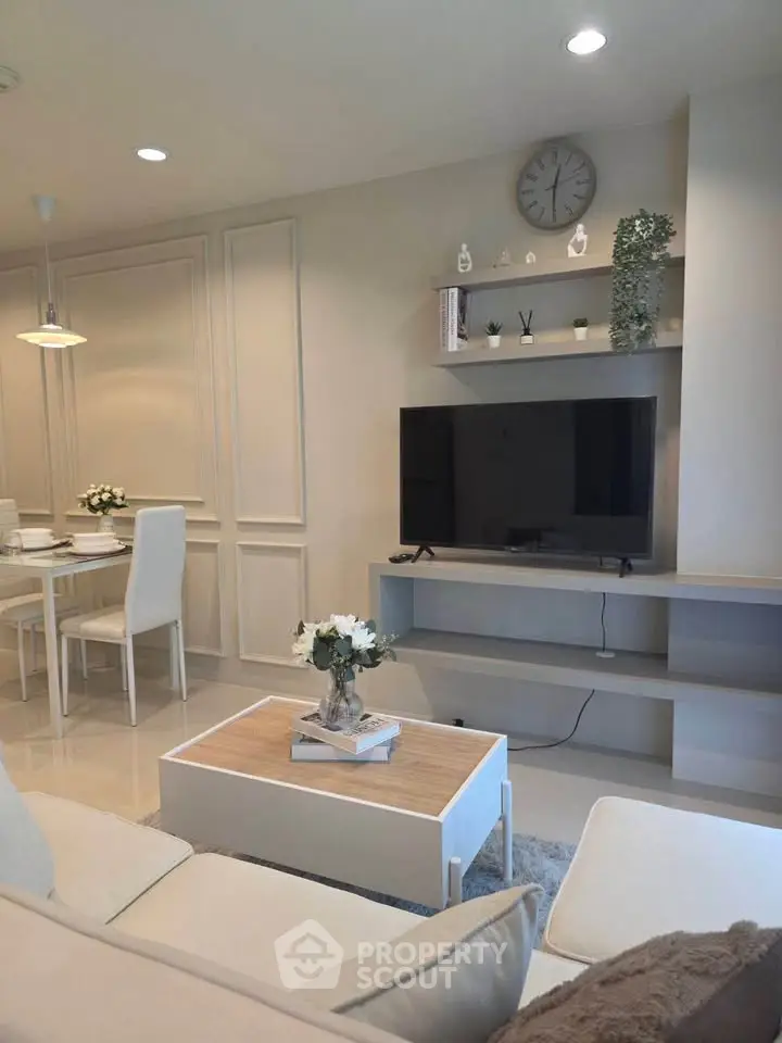 Elegant living room with modern decor and wall-mounted TV, perfect for stylish urban living.