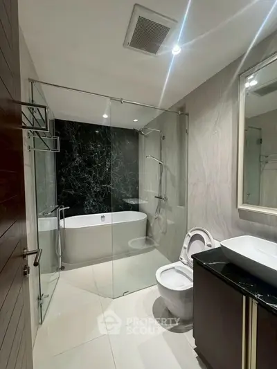 Luxurious modern bathroom with glass shower and elegant bathtub