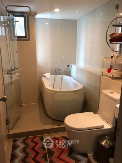 Modern bathroom with sleek bathtub and glass shower enclosure