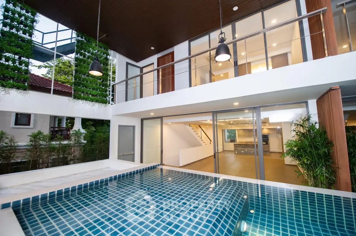 Luxurious modern home with stunning pool and open-plan interior design