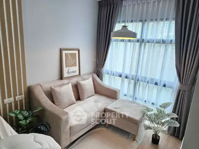 Chic living room with elegant sofa and large window, perfect for modern urban living.