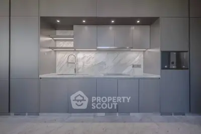 Sleek modern kitchen with minimalist design and marble backsplash