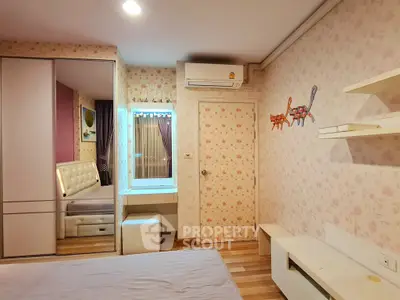 Charming bedroom with floral wallpaper and modern furnishings, featuring a cozy bed and built-in wardrobe.