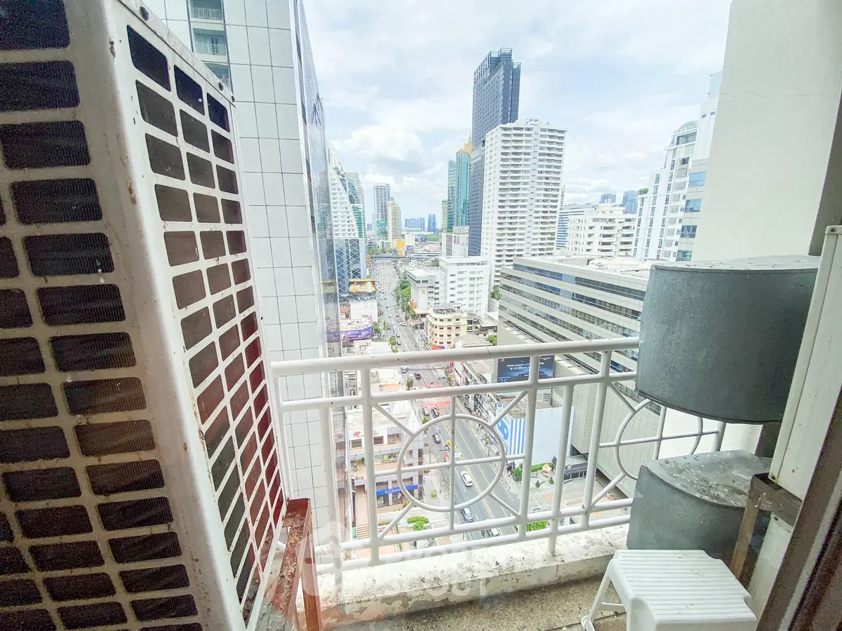 Stunning city view from a high-rise balcony in a modern urban setting.