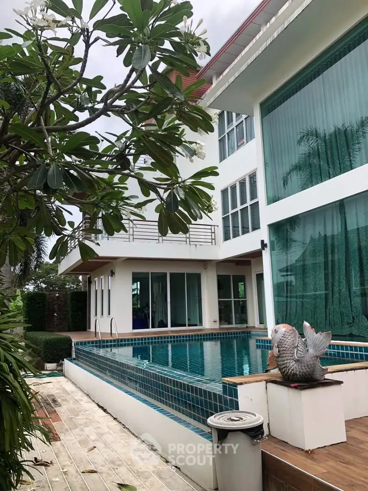 Luxurious modern villa with private pool and lush greenery, perfect for serene living.