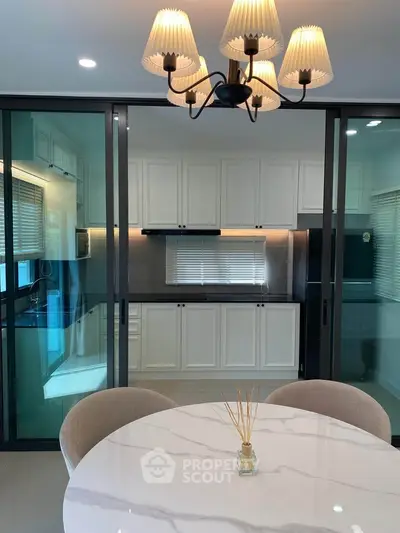 Modern kitchen with elegant dining area and stylish lighting