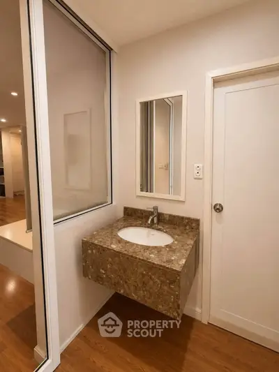 Modern bathroom with elegant sink and wooden flooring